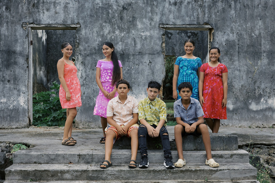 The original Coral Kids in front of an abandoned traditional coral house with an important history on the island.